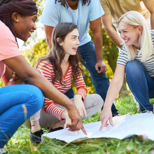 a group of people sitting on the grass