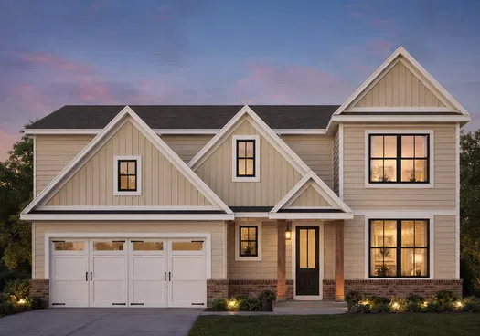 Modern two-story beige house with large windows and a double garage at sunset with warm interior lights.